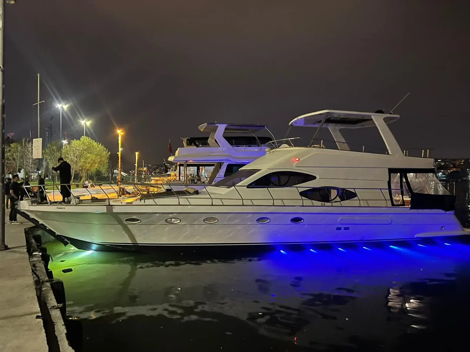 A private yacht moored on the Bosphorus at night, lit blue from below, Istanbul
